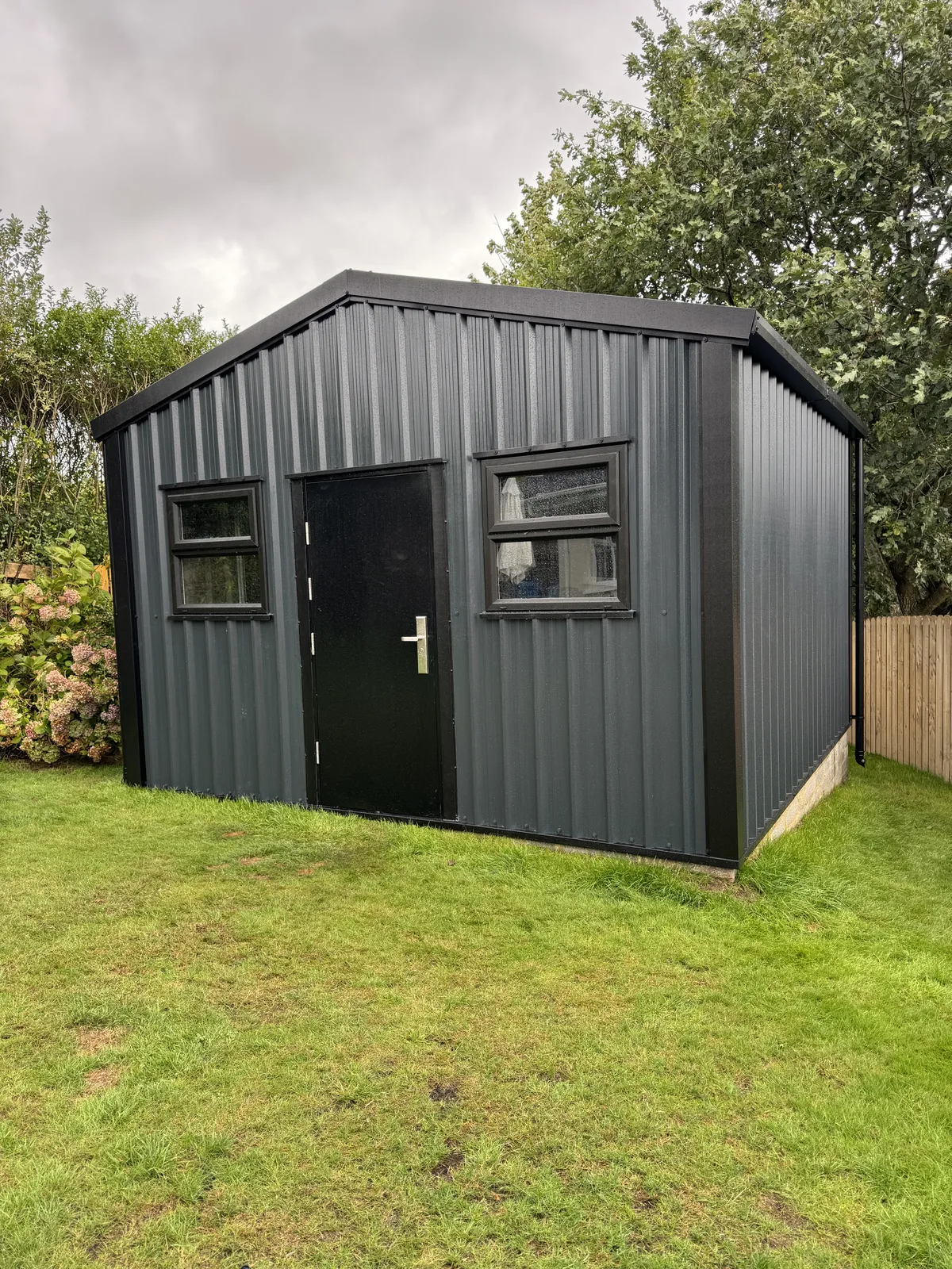Charcoal steel shed with windows and a black door